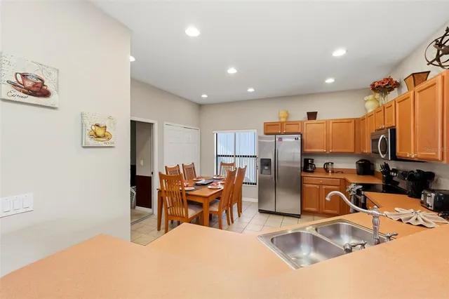 a kitchen with stainless steel appliances granite countertop a refrigerator and a sink
