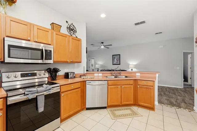 a kitchen with stainless steel appliances a stove sink microwave and cabinets