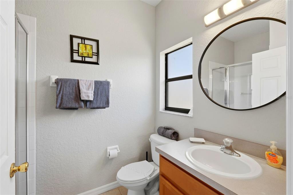 16602 Lazy Breeze Loop Clermont, FL 34714 - Photo 22 of 51 a bathroom with a toilet a sink and a mirror