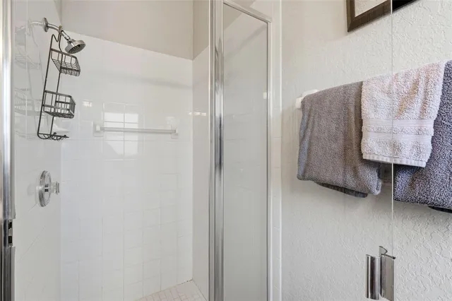 a bathroom with a shower and a sink