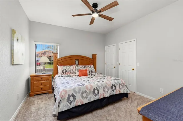 a bedroom with a bed a dresser and a painting