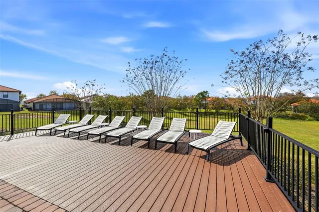 a view of a house with a small yard and wooden fence