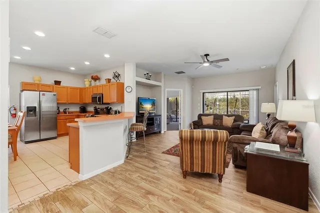 a living room with furniture and kitchen view