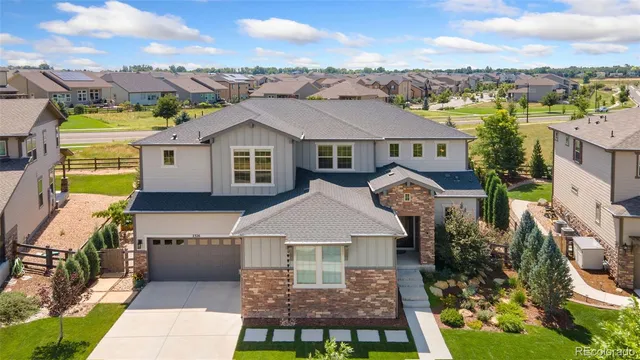 a view of a big house with a big yard and large trees