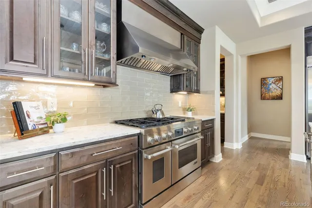 a kitchen with stainless steel appliances granite countertop a stove and a sink