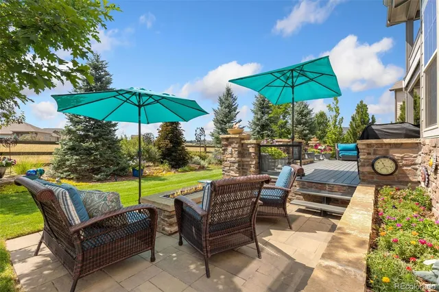 a patio with a patio table and chairs