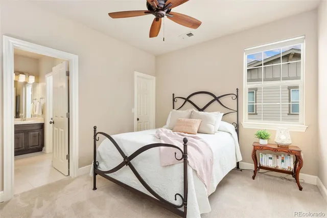a bedroom with a bed a window and a chandelier
