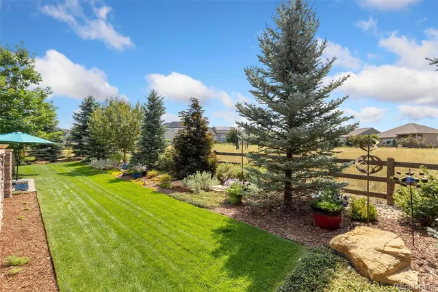 a view of a backyard with sitting area