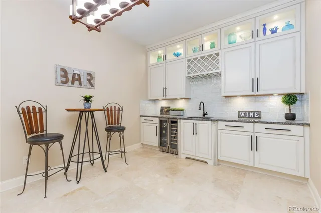 a kitchen with cabinets and chairs