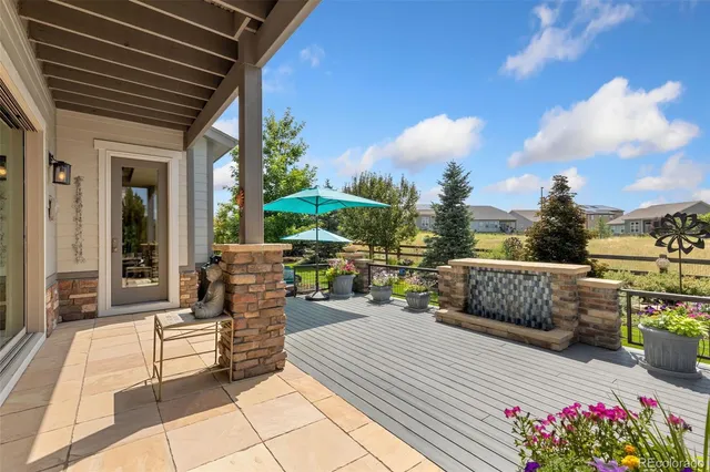 a view of a patio with dining table and chairs with a fire pit
