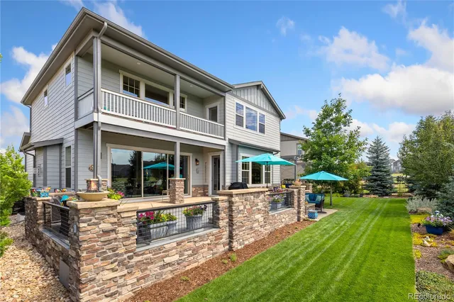 a front view of a house with swimming pool and sitting area