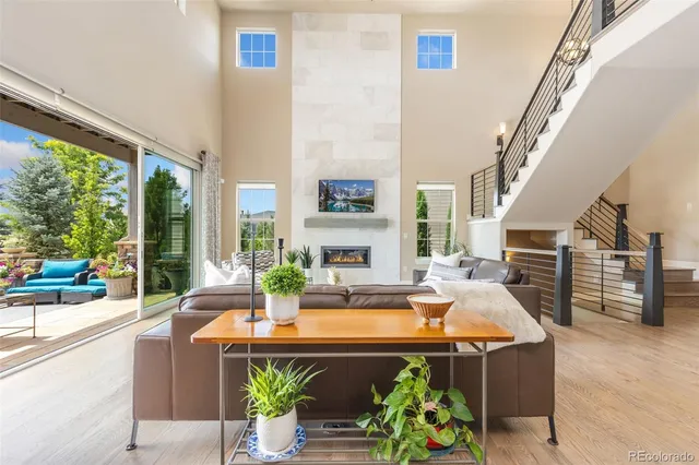 a living room with fireplace furniture and a large window