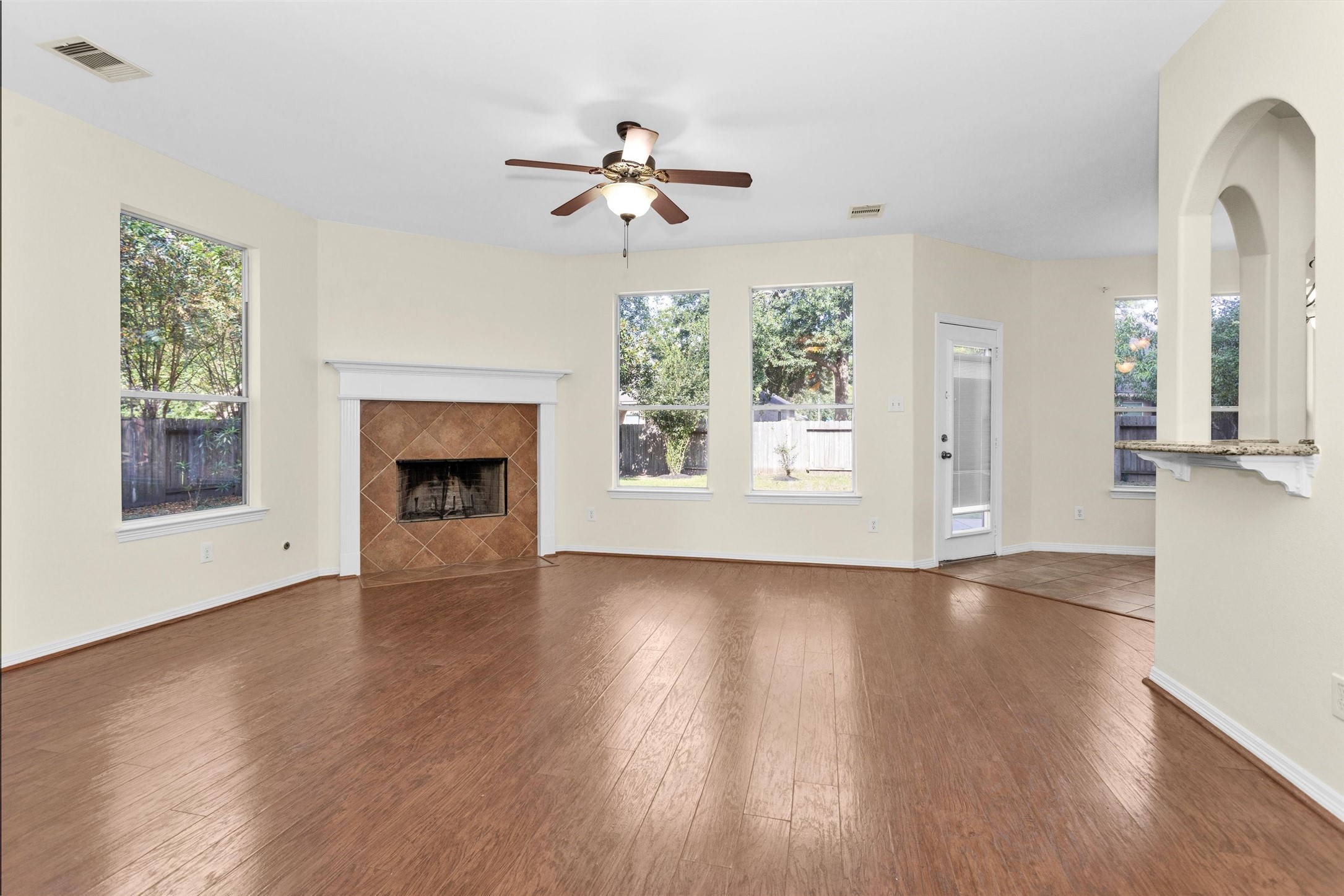 2 Lulach Circle Conroe, TX 77301 - Photo 11 of 30 Family room featuring fireplace and ceiling fan and windows galore
