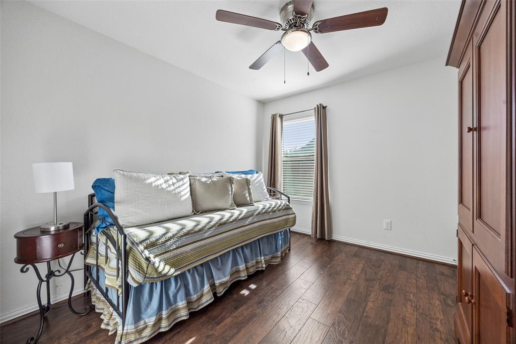 406 Madrone Lane Princeton, TX 75407 - Photo 18 of 30 Bedroom featuring wood-finish flooring, a ceiling fan with integrated lighting, a window with blinds and drapes