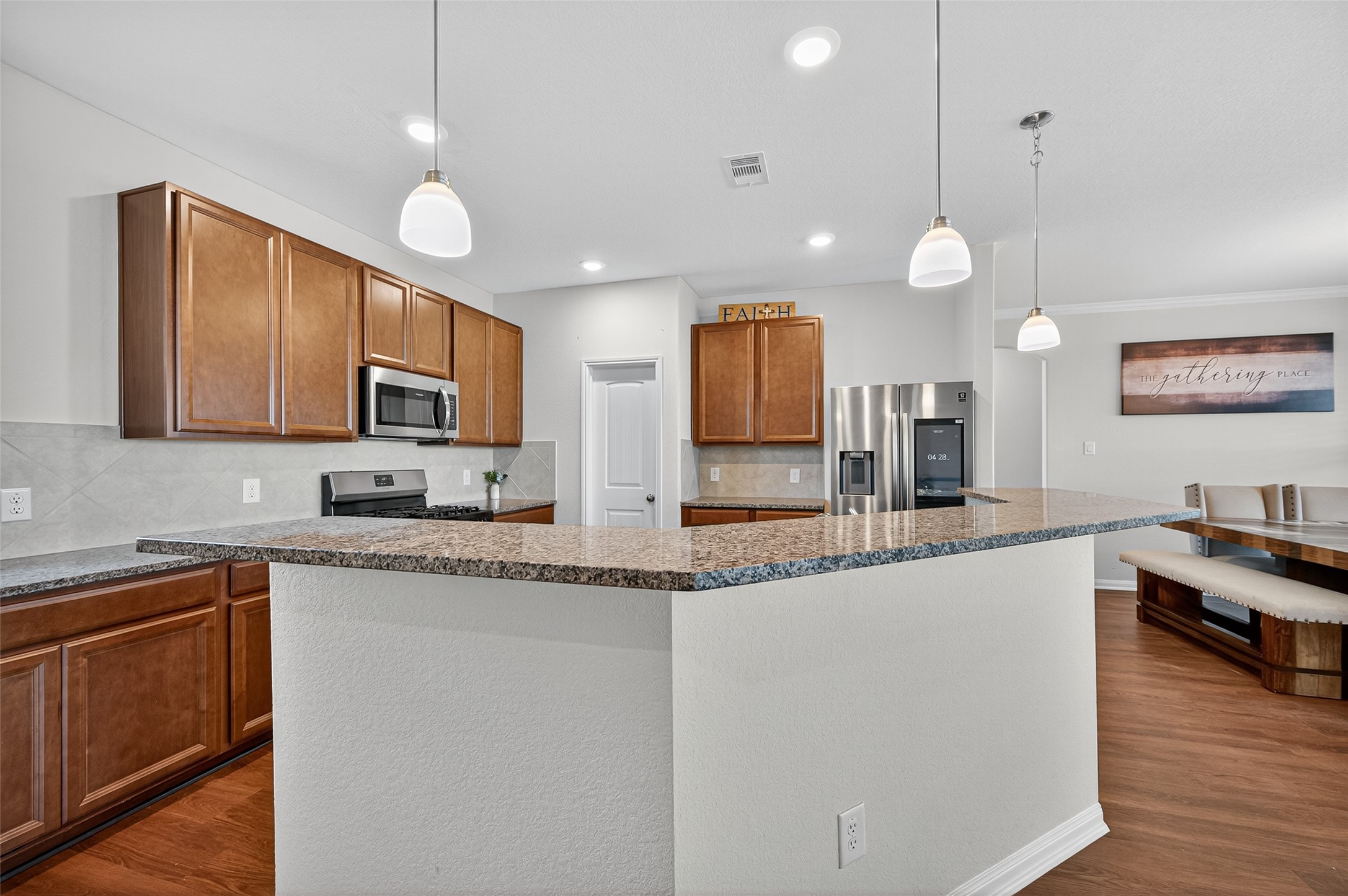 8007 Lehman Road Beasley, TX 77417 - Photo 11 of 47 a large kitchen with granite countertop a sink a counter space appliances and cabinets