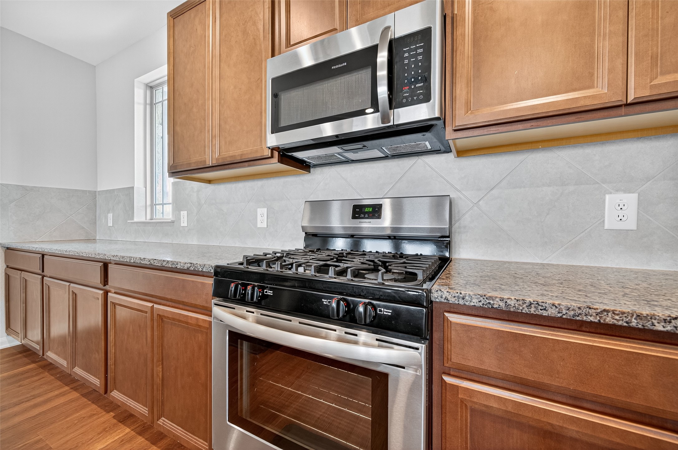8007 Lehman Road Beasley, TX 77417 - Photo 14 of 47 a kitchen with stainless steel appliances granite countertop white cabinets and a stove top oven