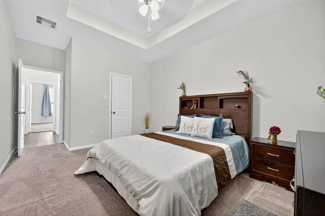 a bedroom with a bed and a chandelier