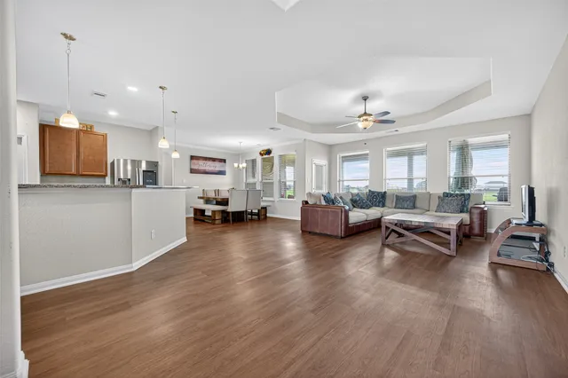 a living room with furniture and a wooden floor