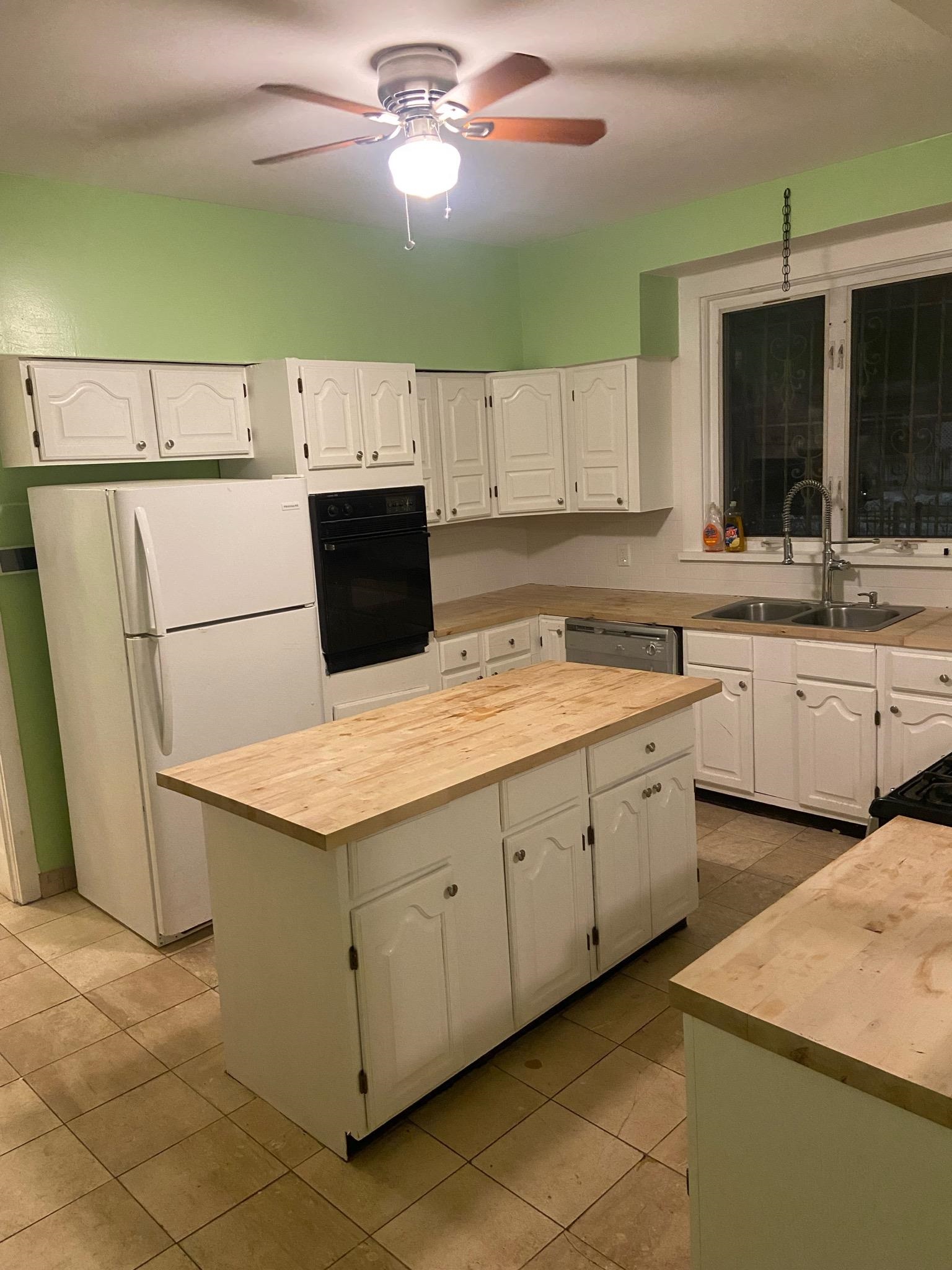 725 Elizabeth Avenue Newark, NJ 07112 - Photo 3 of 7 a kitchen with a sink a stove and cabinets