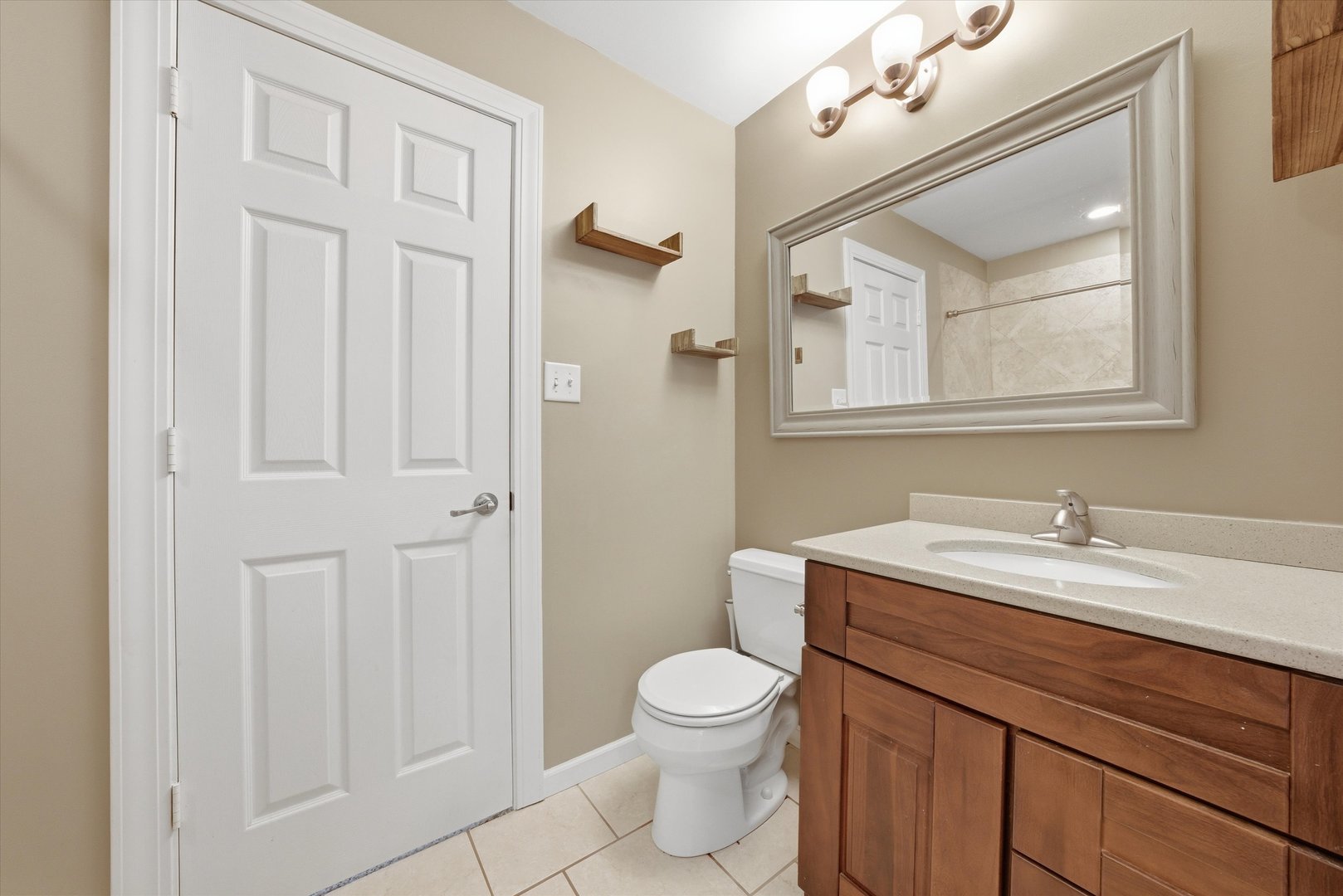 3517 Jacqueline Drive Crete, IL 60417 - Photo 15 of 26 a bathroom with a toilet a sink a mirror a vanity and window