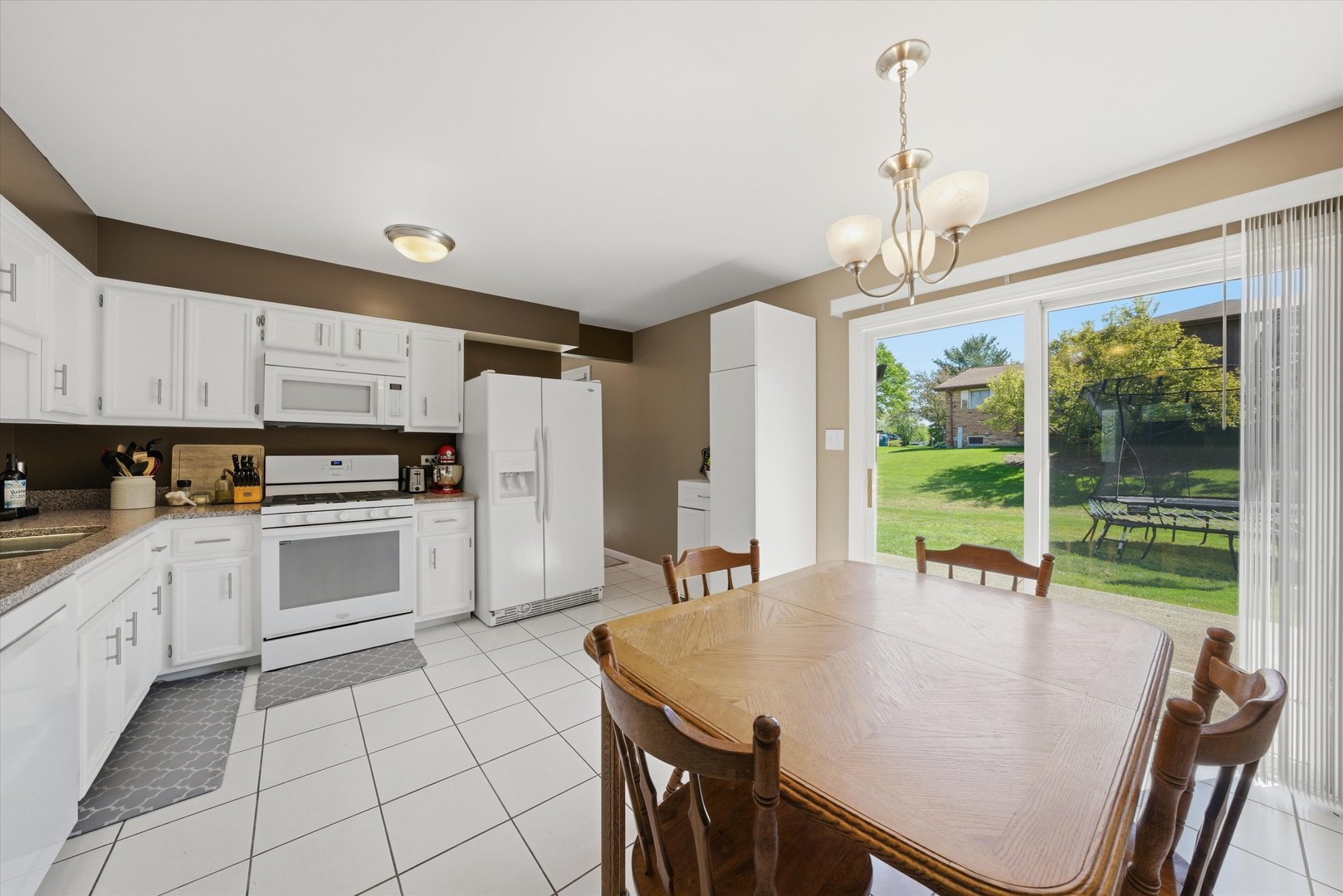 3517 Jacqueline Drive Crete, IL 60417 - Photo 7 of 26 a kitchen with stainless steel appliances granite countertop a stove a sink a microwave and a refrigerator