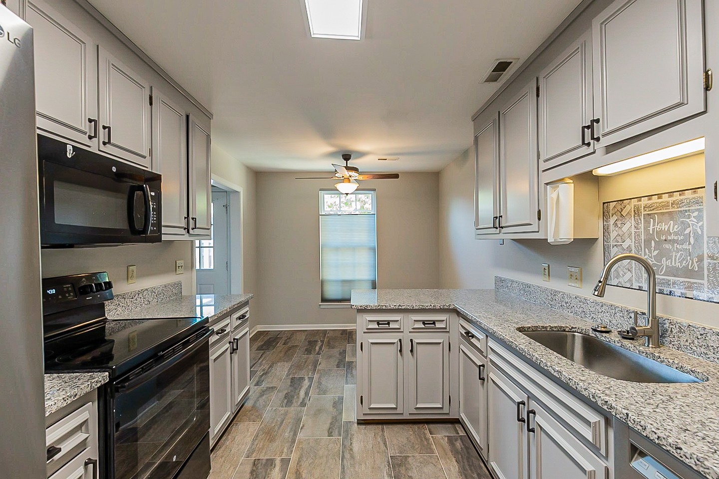 896 General George Patton Road Nashville, TN 37221 - Photo 8 of 23 a kitchen with granite countertop a sink stainless steel appliances and cabinets