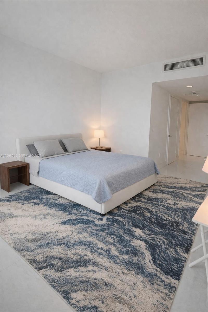 92 Southwest 3rd Street, Unit 2510 Miami, FL 33130 - Photo 11 of 35 a bedroom with a bed and a cabinets