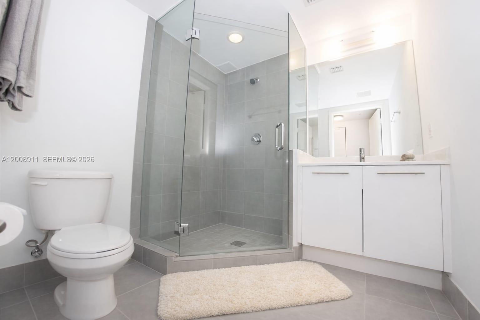 92 Southwest 3rd Street, Unit 2510 Miami, FL 33130 - Photo 12 of 35 a bathroom with a toilet a sink and shower
