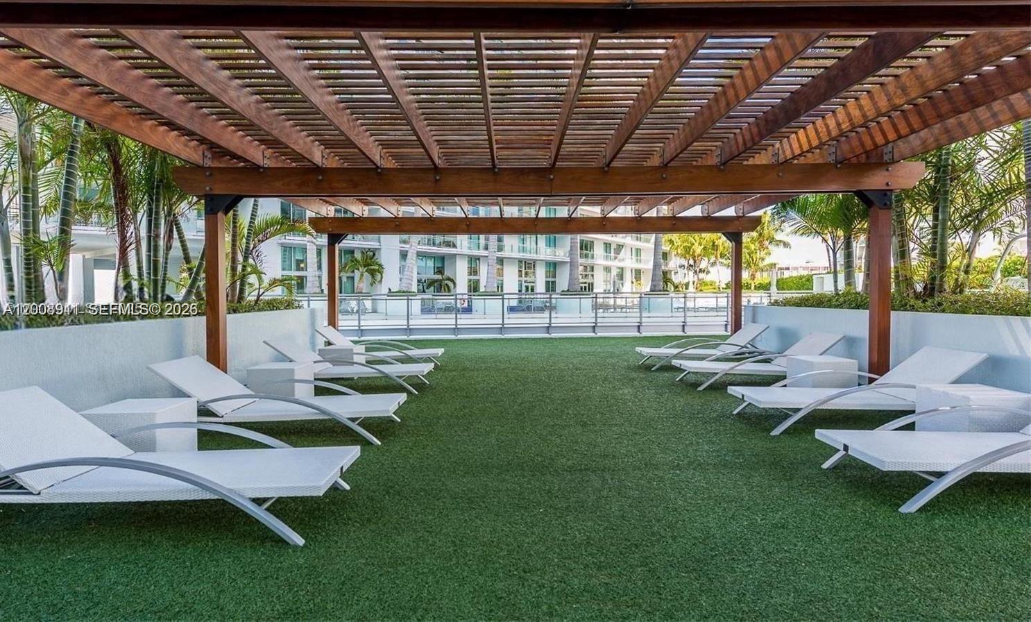 92 Southwest 3rd Street, Unit 2510 Miami, FL 33130 - Photo 18 of 35 a front view of a house with garden and patio