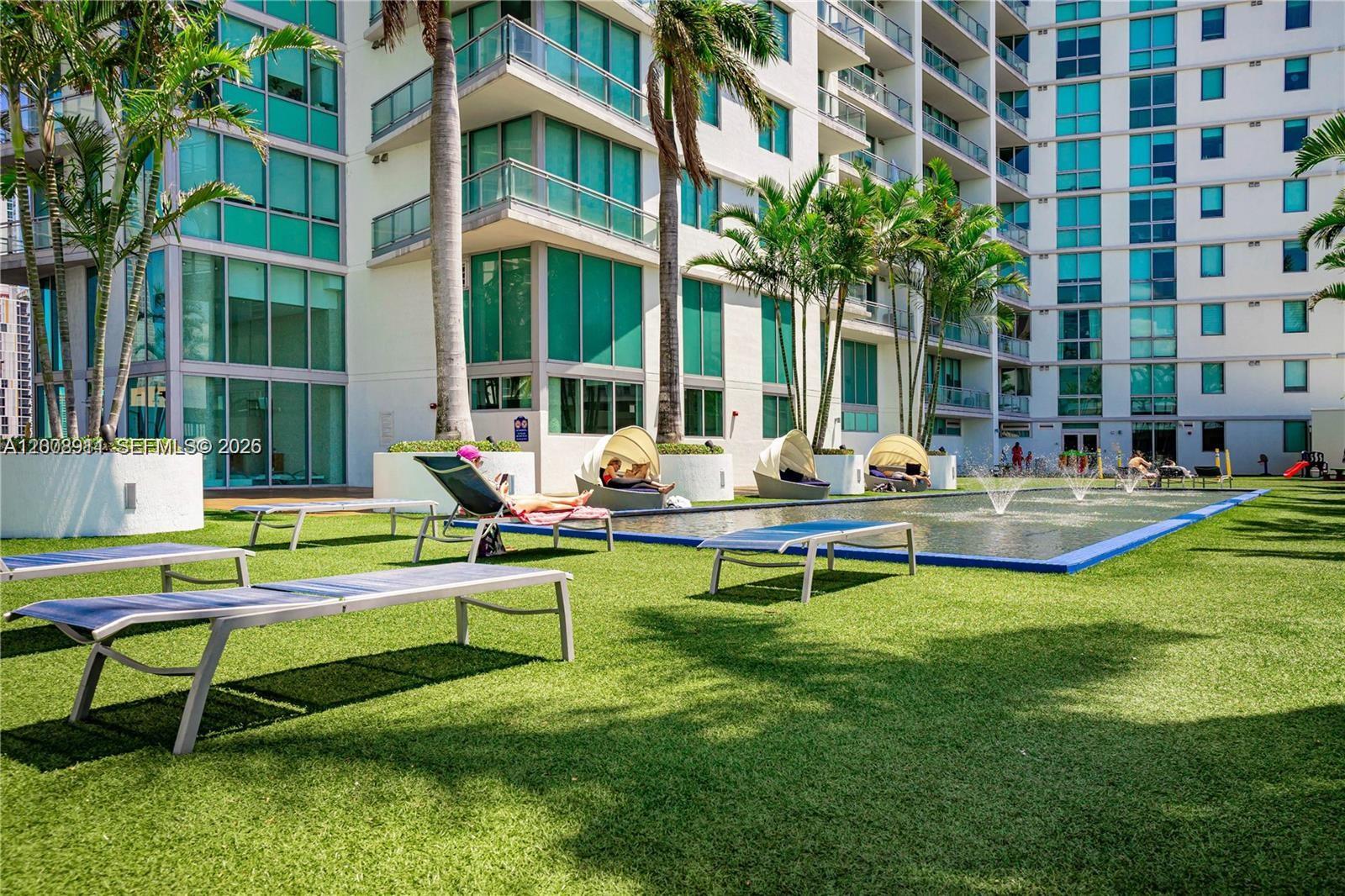 92 Southwest 3rd Street, Unit 2510 Miami, FL 33130 - Photo 26 of 35 a pool with outdoor seating and yard
