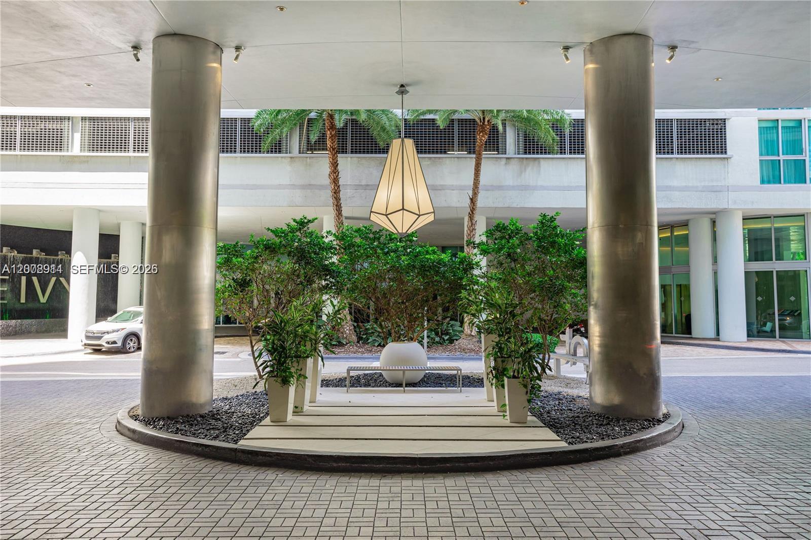92 Southwest 3rd Street, Unit 2510 Miami, FL 33130 - Photo 30 of 35 a view of a lobby with chair and potted plants