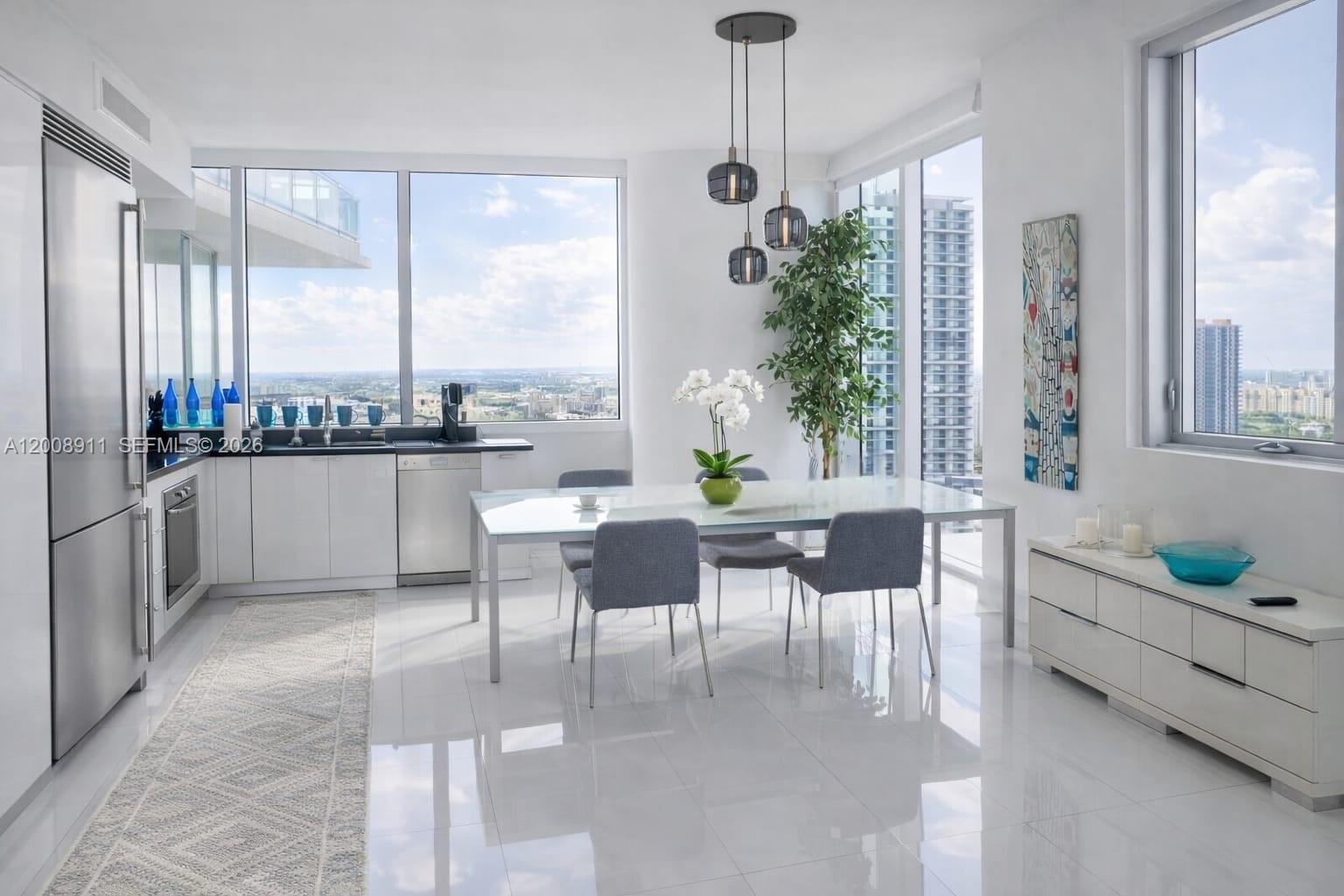 92 Southwest 3rd Street, Unit 2510 Miami, FL 33130 - Photo 3 of 35 a dining room with furniture a chandelier and a rug