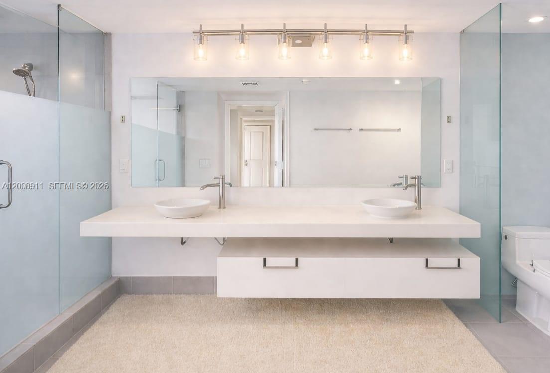 92 Southwest 3rd Street, Unit 2510 Miami, FL 33130 - Photo 8 of 35 a bathroom with a sink a mirror and a bathtub