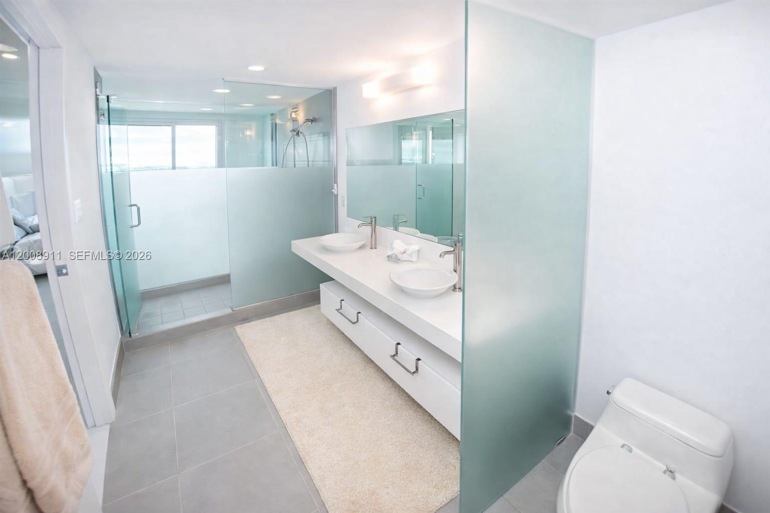 92 Southwest 3rd Street, Unit 2510 Miami, FL 33130 - Photo 9 of 35 a bathroom with a sink toilet and shower