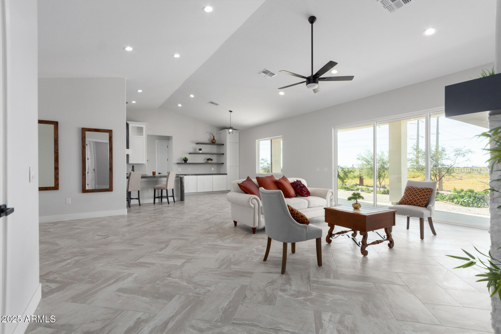 19657 West Dunlap Road Buckeye, AZ 85326 - Photo 11 of 45 a dining room with furniture a chandelier and a floor to ceiling window