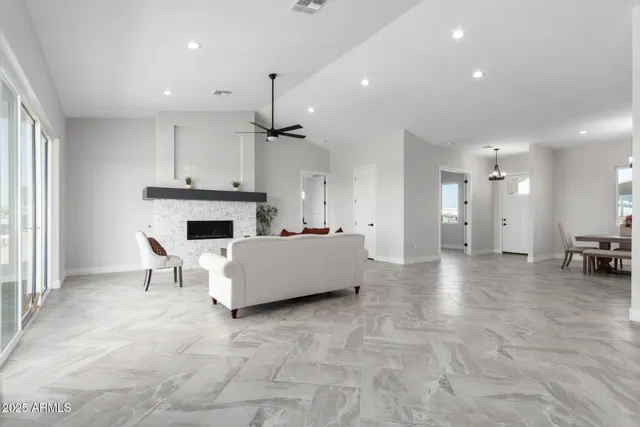 a large kitchen with stainless steel appliances a large counter top a stove and a refrigerator