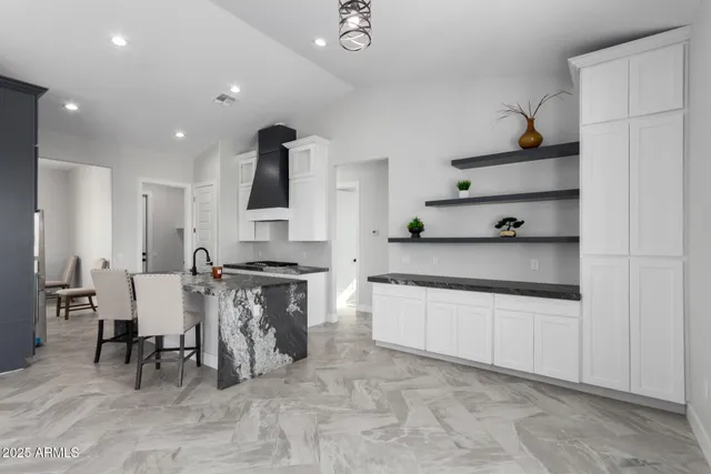 a large kitchen with stainless steel appliances lots of counter top space