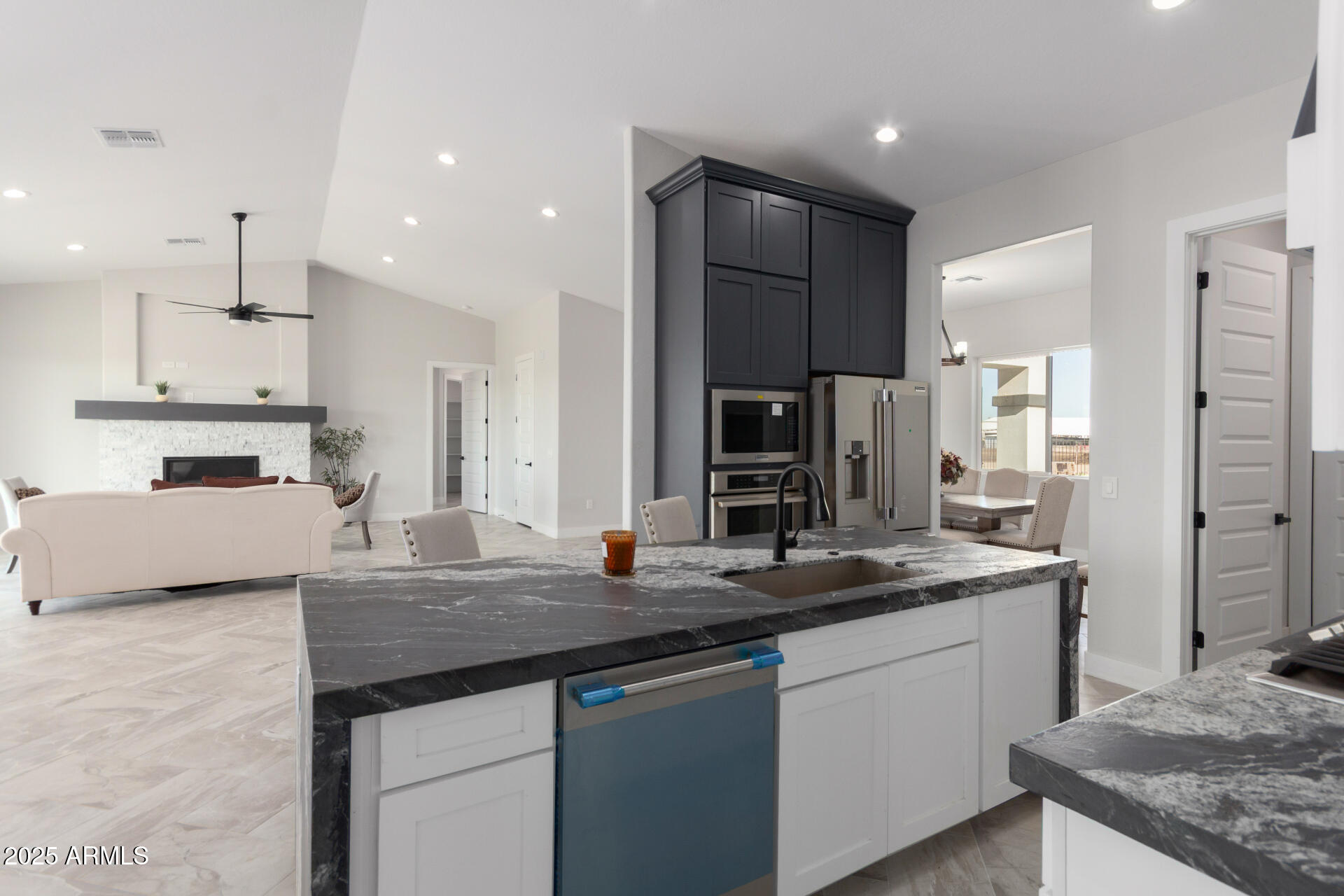 19657 West Dunlap Road Buckeye, AZ 85326 - Photo 18 of 45 a kitchen with stainless steel appliances granite countertop a sink stove and refrigerator