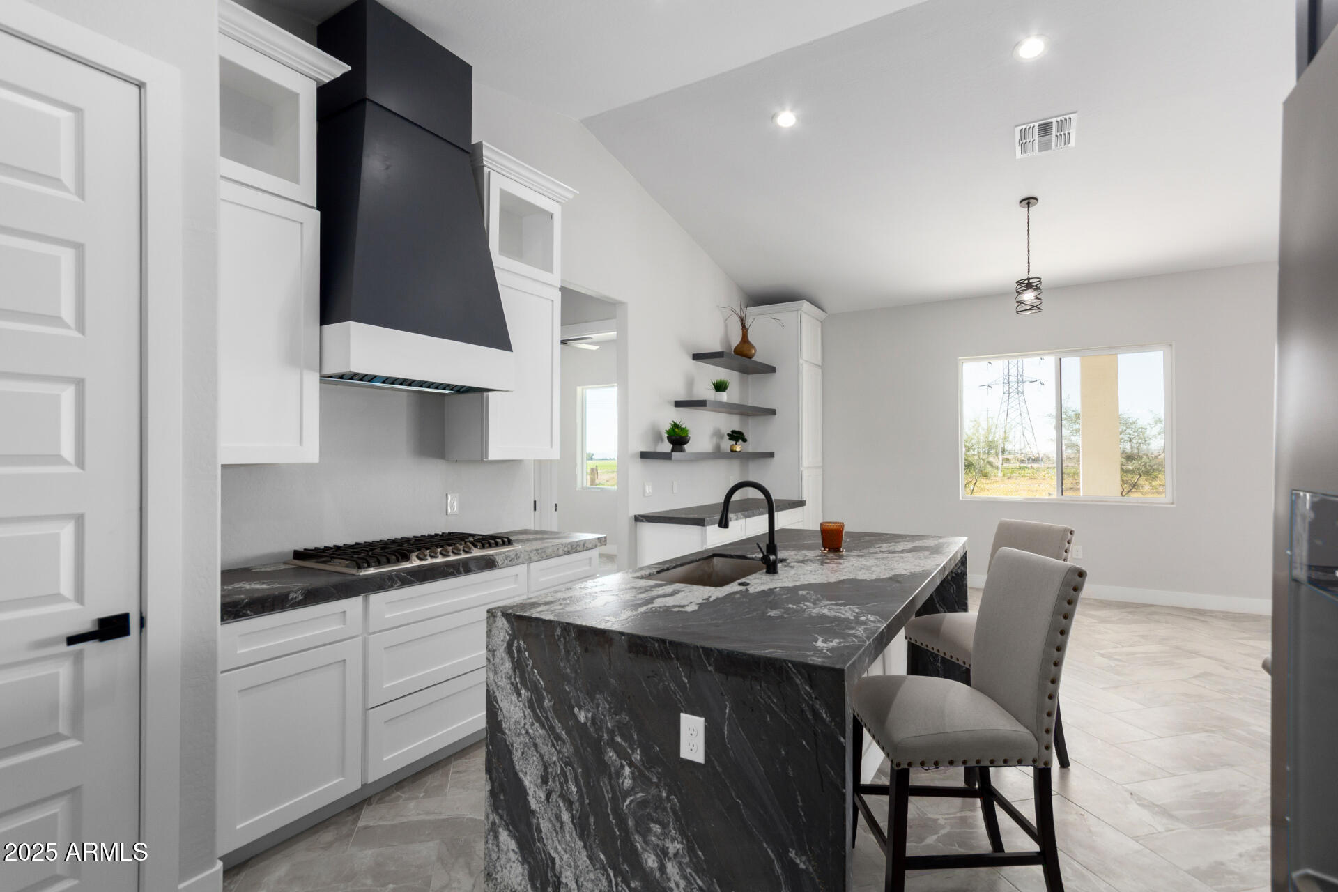 19657 West Dunlap Road Buckeye, AZ 85326 - Photo 20 of 45 a kitchen with stainless steel appliances a sink a stove a table and chairs