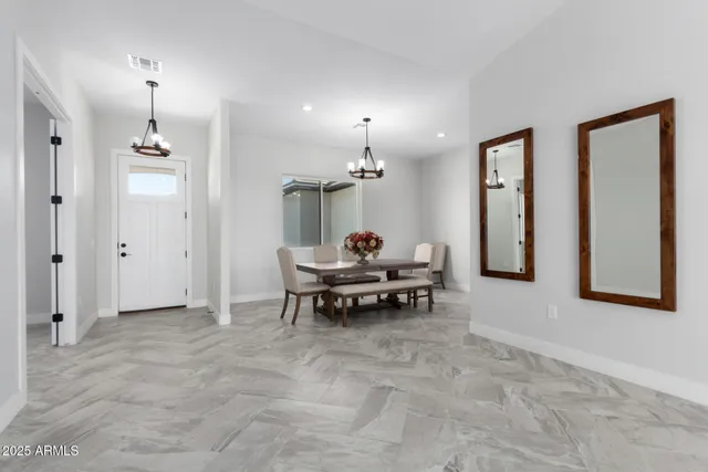 a view of a dining room with furniture and chandelier