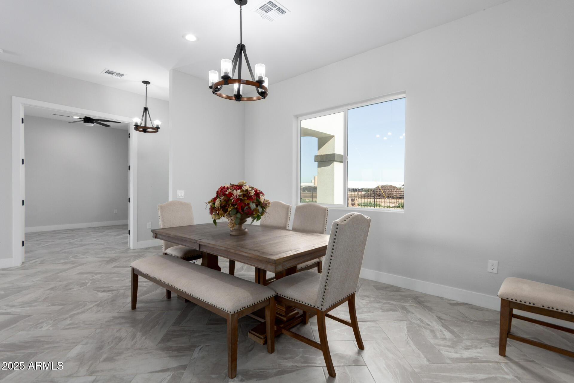 19657 West Dunlap Road Buckeye, AZ 85326 - Photo 23 of 45 a view of a dining room with furniture and chandelier