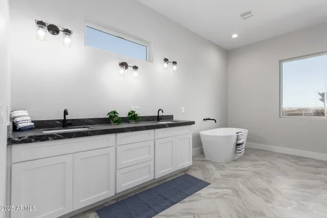 a bathroom with a bathtub and a window