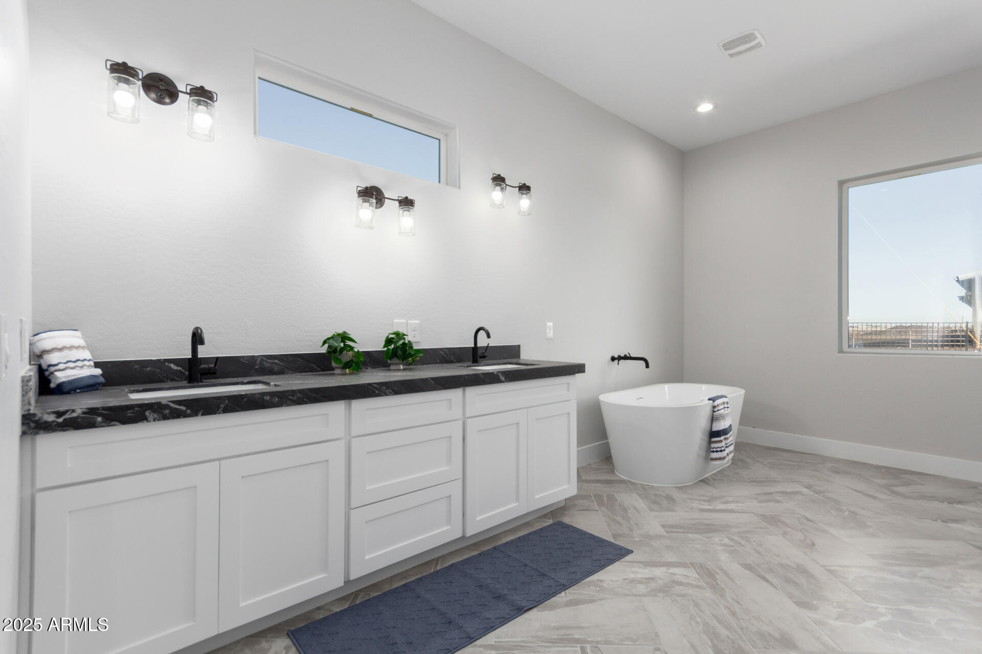 19657 West Dunlap Road Buckeye, AZ 85326 - Photo 27 of 45 a spacious bathroom with a granite countertop sink and a mirror