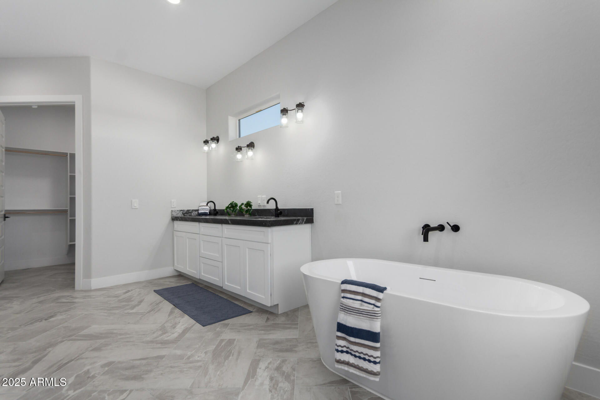 19657 West Dunlap Road Buckeye, AZ 85326 - Photo 29 of 45 a bathroom with a bathtub and a window