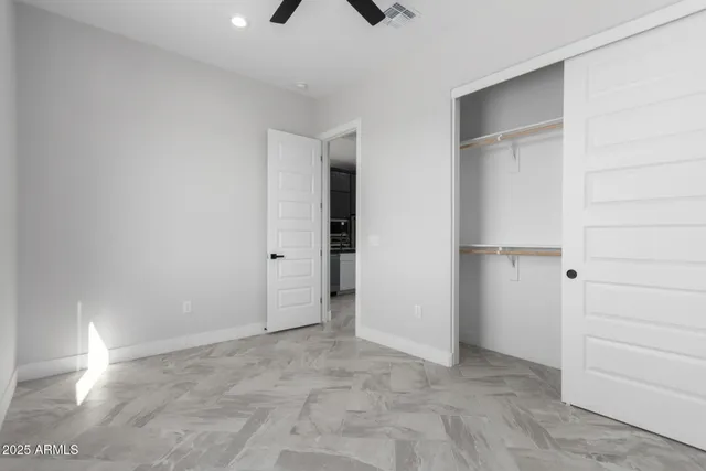 an empty room with a natural light and window