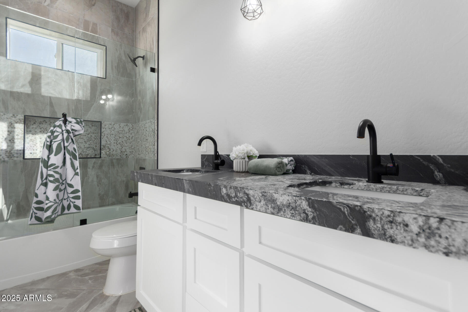 19657 West Dunlap Road Buckeye, AZ 85326 - Photo 37 of 45 a bathroom with a granite countertop sink a toilet and a shower