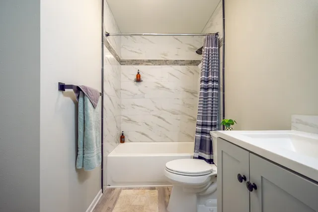 a bathroom with a sink toilet and shower