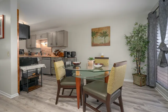 a view of a dining room with furniture and wooden floor