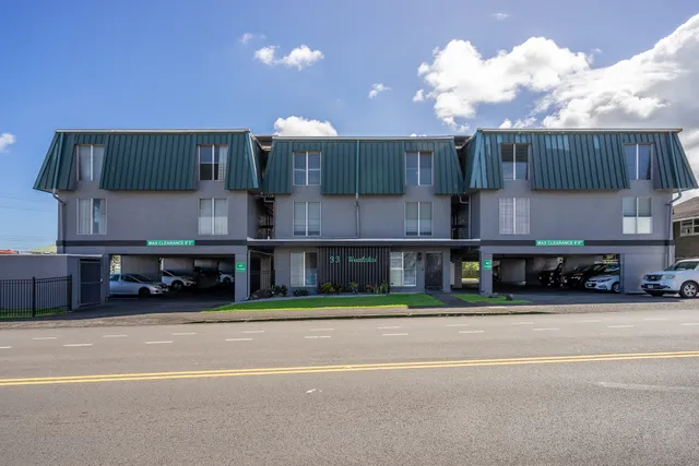 a view of a car park in front of a house