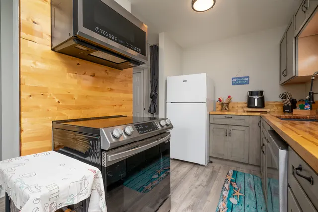 a kitchen with a refrigerator and a stove top oven